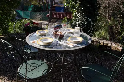 a table with plates and glasses on top of it at Loft Vacarisses Torreblanca Estación, Piscina Privada in Vacarisas
