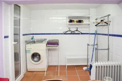 a laundry room with a washer and a washing machine at Loft Vacarisses Torreblanca Estación, Piscina Privada in Vacarisas