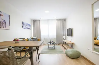 a living room with a table and a dining room at Tendency Apartments Forum 2 in Barcelona