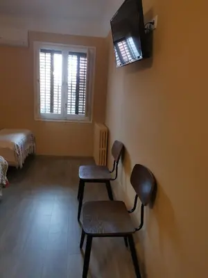 a room with two chairs and a tv on the wall at Cal Duran in Esparreguera