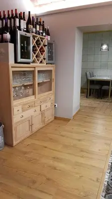 a room with a large wooden cabinet with bottles of wine at Cal Duran in Esparreguera