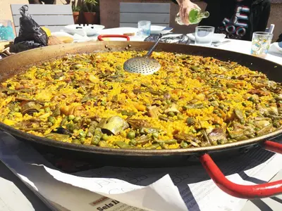 a large pan of food sitting on a table at Espectacular ático dúplex con vistas al mar in Cunit