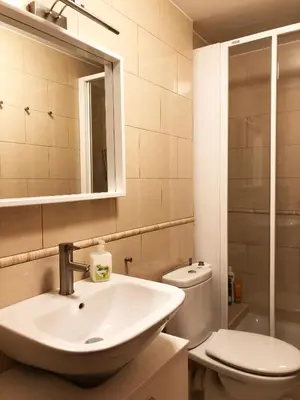 a bathroom with a sink and a toilet at Espectacular ático dúplex con vistas al mar in Cunit