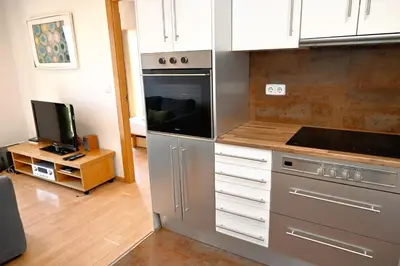 a kitchen with stainless steel appliances and a television at Homenfun Barcelona Plaza España in Barcelona