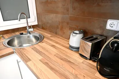 a kitchen counter with a sink and a toaster at Homenfun Barcelona Plaza España in Barcelona