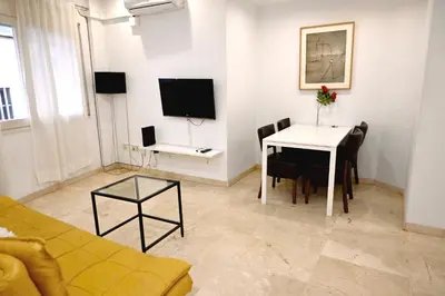 a living room with a table and a tv at Homenfun Barcelona Sagrada Familia Lepanto in Barcelona