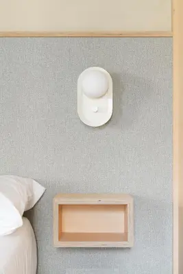 a room with a bed and a wall with a alarm clock at Decô Apartments Barcelona-Born St. in Barcelona