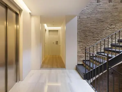 a hallway with stairs and a brick wall at Decô Apartments Barcelona-Born Apt. in Barcelona