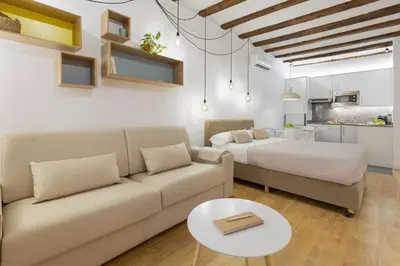 a living room with a couch and a bed at Ola Living Born in Barcelona