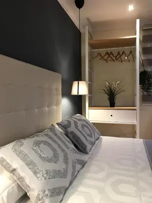 a bedroom with a large white bed with a headboard at LOFT A 20' DE BARCELONA Y 7' DE LA UAB. in Barbera del Valles