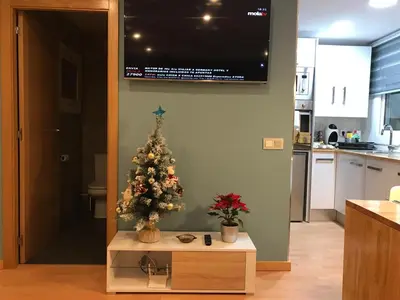 a christmas tree sitting on a table in a kitchen at LOFT A 20' DE BARCELONA Y 7' DE LA UAB. in Barbera del Valles