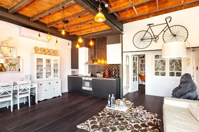 a kitchen and living room with a bike hanging from the ceiling at Luxury Penthouses 1 in Barcelona