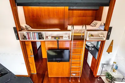 a tiny house with a tv and a bunk bed at Luxury Penthouses 2 in Barcelona