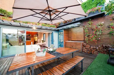 a patio with a table and an umbrella at Luxury Penthouses 2 in Barcelona