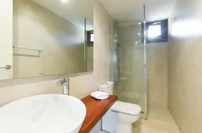 a bathroom with a toilet and a glass shower at Masia el Prat in El Pont de Vilomara
