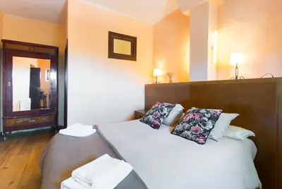 a bedroom with a large bed with two pillows at Masia el Prat in El Pont de Vilomara