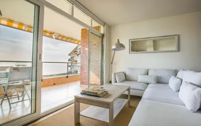 a living room with a couch and a table at GAVA4 BEACHFRONT Apartment BARCELONA in Gavà