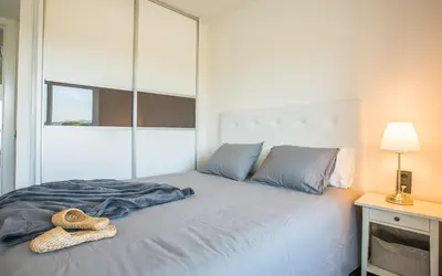 a bedroom with a large bed with a large mirror at GAVA4 BEACHFRONT Apartment BARCELONA in Gavà
