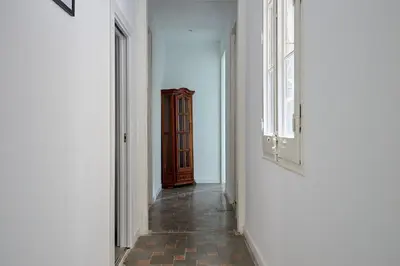 an empty corridor with a door and a hallway with a floor at Key Barcelona HOUSING (Carrer Girona) in Barcelona