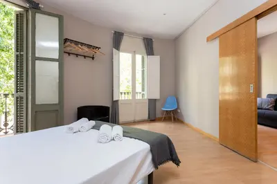 a bedroom with a bed with two towels on it at Key Barcelona HOUSING (Carrer Girona) in Barcelona