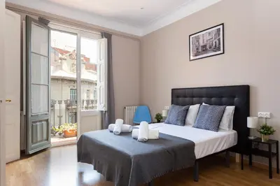 a bedroom with a bed with two towels on it at Key Barcelona HOUSING (Carrer Girona) in Barcelona