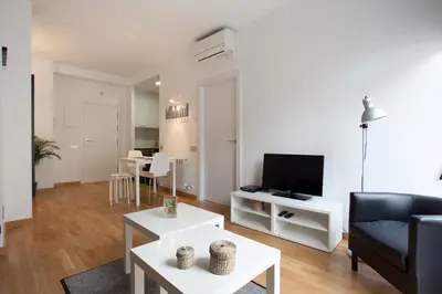 a living room with a couch and a tv at AB Gracia Sant Salvador in Barcelona