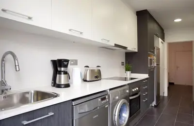 a kitchen with a sink and a dishwasher at AB Gracia Sant Salvador in Barcelona