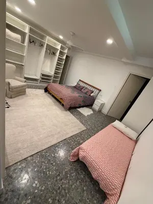 a room with two beds and a couch in it at Apartamento con piscina cerca de Barcelona in Masnou