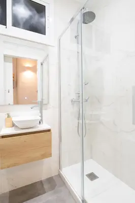 a white bathroom with a toilet and a sink at Sagrada Familia Comfy apartment in Barcelona