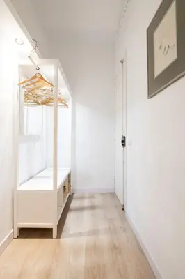 a chair sitting on a balcony with windows at Sagrada Familia Comfy apartment in Barcelona
