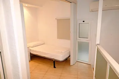 a small room with a bed and a window at Homenfun Barcelona Sagrada Familia Glories in Barcelona