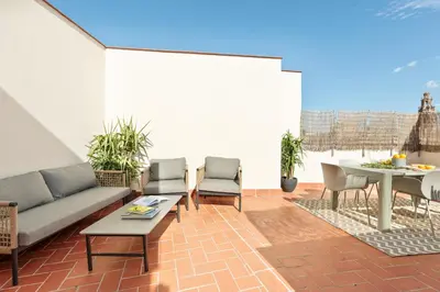 a living room with a couch and chairs and a table at Inspired by EnjoyApartments in Barcelona
