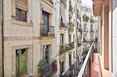 an apartment building in paris with balconies and plants at Inspired by EnjoyApartments in Barcelona