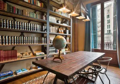 a table with a globe on it in a library at Midtown Luxury Apartments by Sweett in Barcelona