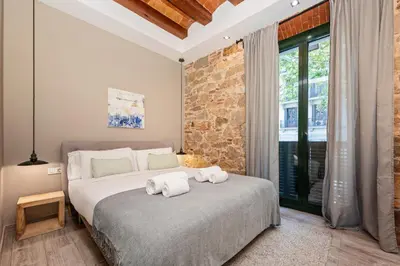 a bedroom with a bed with towels on it at Midtown Luxury Apartments by Sweett in Barcelona