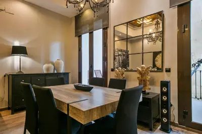 a dining room with a wooden table and chairs at Midtown Luxury Apartments by Sweett in Barcelona