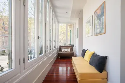 a living room with a couch and windows at Art House Granvia in Barcelona
