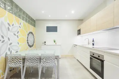 a kitchen with a table and chairs in a room at Art House Granvia in Barcelona