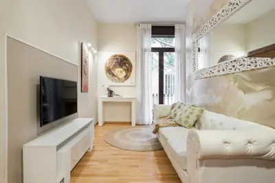 a living room with a white couch and a television at Art House Sagrada Familia in Barcelona
