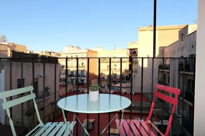 a table and two chairs sitting on a balcony at ClassBedroom Port Ramblas in Barcelona