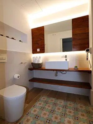 a bathroom with a toilet and a sink and a mirror at ClassBedroom Port Ramblas in Barcelona