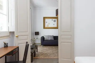 a living room with a blue couch and a door at Casa Cosi - Mallorca 2 in Barcelona