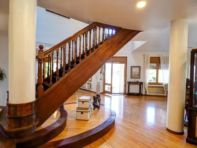 a living room with a wooden staircase in a house at Villa El Faro by Hello Homes Sitges in Vilanova i la Geltrú