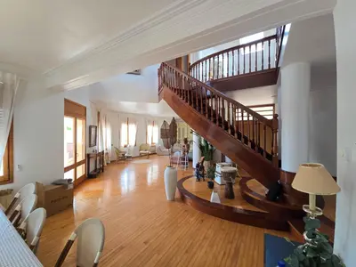a large living room with a staircase in a house at Villa El Faro by Hello Homes Sitges in Vilanova i la Geltrú