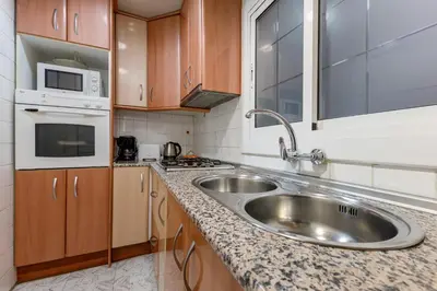 a kitchen with a sink and a microwave at Besos · Bright apartment close to congress & port in Sant Adria de Besos