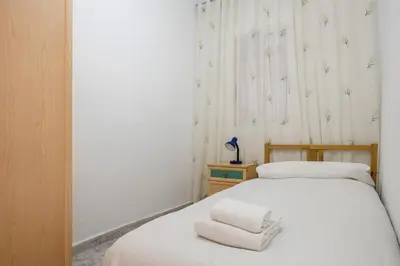a bedroom with two beds with towels on the bed at Besos · Bright apartment close to congress & port in Sant Adria de Besos