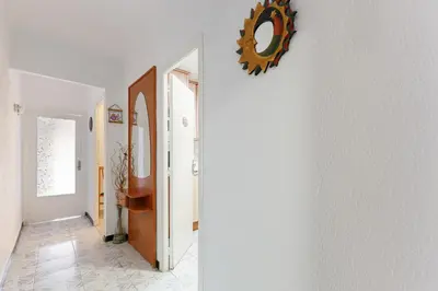 a hallway with white walls and a mirror on a wall at Besos · Bright apartment close to congress & port in Sant Adria de Besos