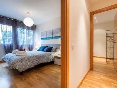 a bedroom with a bed and a large window at Stay Barcelona Maragall in Barcelona