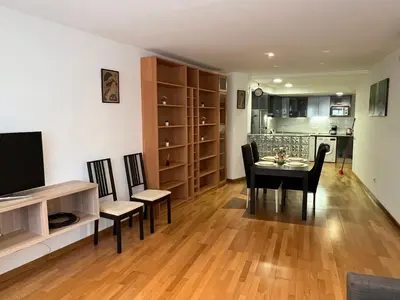 a dining room with a table and chairs and a kitchen at Stay Barcelona Maragall in Barcelona