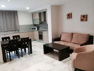 a living room with a couch and a table at Aparthotel del Golf in Sant Cugat del Vallès